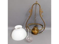A decorative hanging ceiling light with glass shad