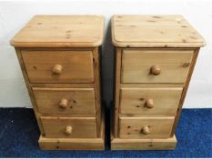 A matching pair of pine bedside cabinets, 25in hig