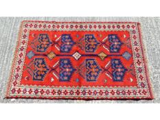 A Persian rug, 73in long x 46in wide