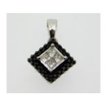 A 10ct white gold pendant set with black & white d