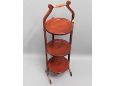 An antique mahogany three tier folding cake stand,