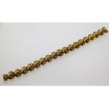 A yellow metal "bark like" bracelet, electronically tests as 9ct gold, 7.25in long, 26.7g