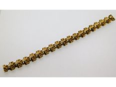A yellow metal "bark like" bracelet, electronically tests as 9ct gold, 7.25in long, 26.7g