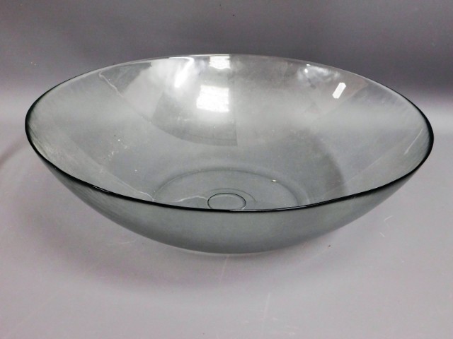 A large glass fruit bowl, 19in diameter, twinned with various soft furnishings