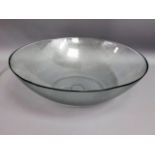 A large glass fruit bowl, 19in diameter, twinned with various soft furnishings