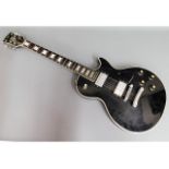 An electric Hondo II Les Paul copy guitar with sof