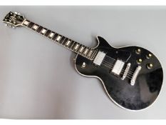 An electric Hondo II Les Paul copy guitar with sof