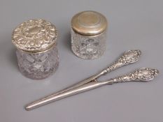 A pair of silver handled glove stretchers twinned