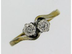 An antique 9ct gold crossover ring with platinum m