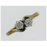 An antique 9ct gold crossover ring with platinum m