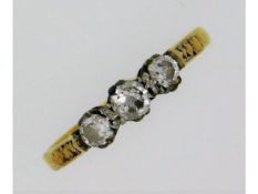 An antique 18ct three stone trilogy ring set with