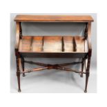 An Edwardian mahogany book trough with shelf over,