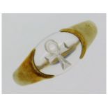 A 9ct gold ring, signed within band Uri Geller, set with intaglio Symbol of Life etched into rock cr