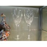 A pair of Waterford crystal wine glasses, one with