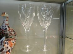 A pair of Waterford crystal wine glasses, one with