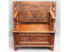 A small carved oak monks bench, 33.5in wide