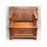 A small carved oak monks bench, 33.5in wide