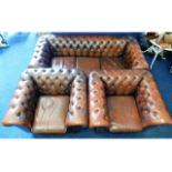 A brown leather Chesterfield style three piece sui