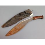 A kukri knife with leather scabbard & wooden handl