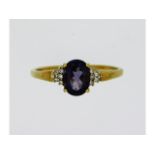 A 9ct gold ring set with amethyst & ten small diam