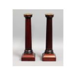 A pair of David Linley stained walnut candlesticks
