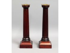 A pair of David Linley stained walnut candlesticks