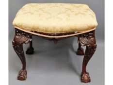 A Victorian style upholstered stool with ball & cl