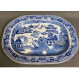 A 19thC. willow pattern meat dish with drainer, 18