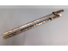 A Tibetan sword with scabbard, 39.75in long, a/f