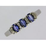 A 9ct white gold ring set with tanzanite & white s