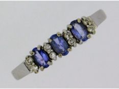 A 9ct white gold ring set with tanzanite & white s