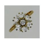 A 9ct gold daisy style ring set with white stones,