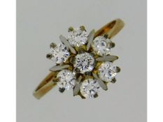 A 9ct gold daisy style ring set with white stones,