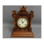 A gothic style Ansonia wooden mantel clock, 15in t