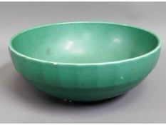 An art deco Wedgwood Keith Murray bowl in green, three small chips, 9.5in diameter