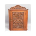 An antique carved corner cabinet, 25in high x 19in wide x 11.5in deep £20-30