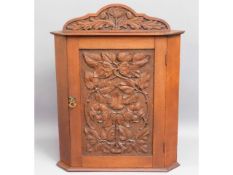 An antique carved corner cabinet, 25in high x 19in wide x 11.5in deep £20-30