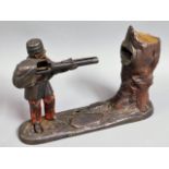 A 19thC. Creedmoor mechanical soldier with gun money box, 6.5in tall x 10in wide, a/f