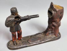 A 19thC. Creedmoor mechanical soldier with gun money box, 6.5in tall x 10in wide, a/f