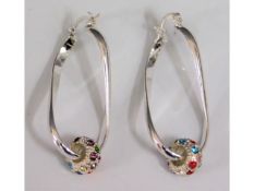 A pair of decorative silver drop earrings