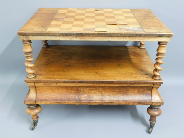 A 19thC. walnut Canterbury converted to a games table, veneer on chess board a/f, 25.75in wide x 21.