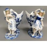 A pair of German Sitzendorf porcelain ornamental spills, one with repair to arm, 7in tall £30-40