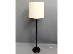 A modern standard lamp twinned with small low leve