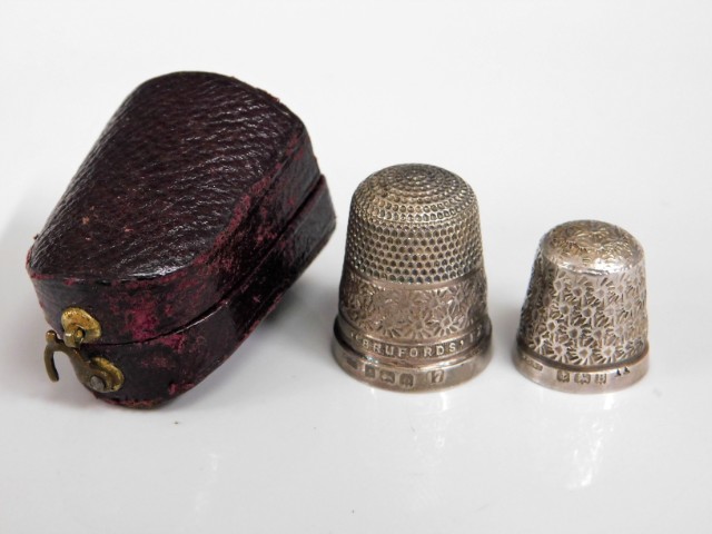 Two silver thimbles, one named "Brufords Exeter",