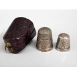 Two silver thimbles, one named "Brufords Exeter",
