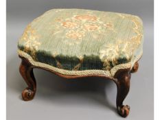 A Victorian upholstered footstool, one foot damage
