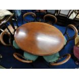 A Victorian mahogany tilt top oval breakfast table with six stained walnut balloon back chairs, 53in