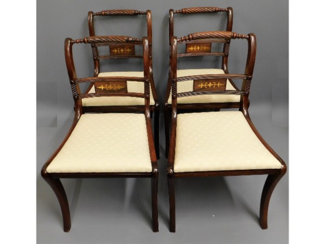 A set of four brass inlaid Regency style mahogany