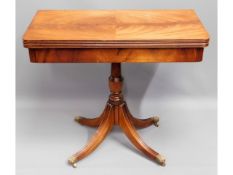 A Regency style mahogany card table with brass cla