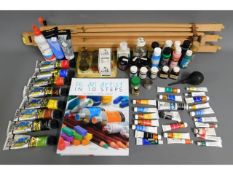 A quantity of artist paints & materials with easel